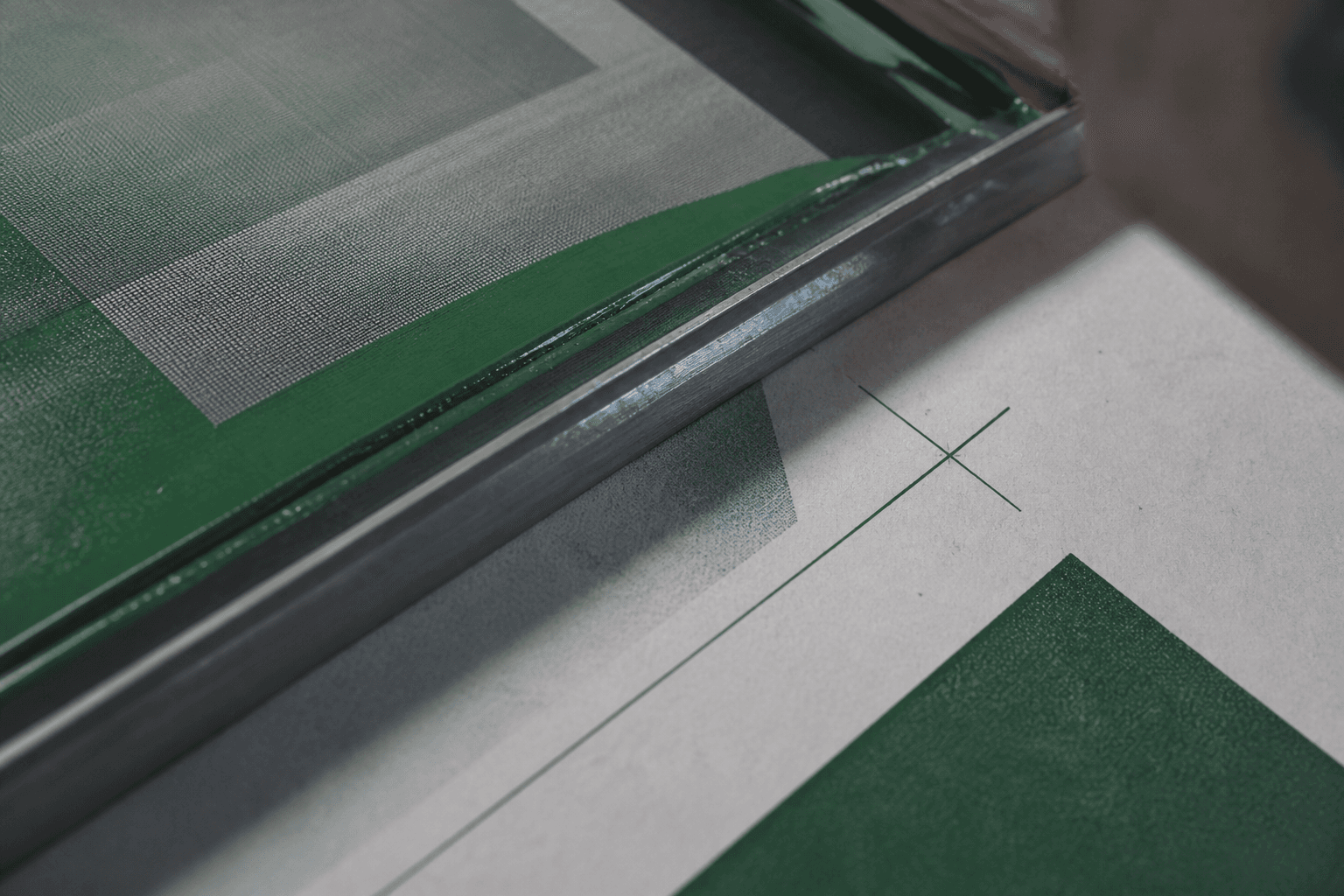 Desk craft: layout sheets, type proofs, and a laptop mid-build